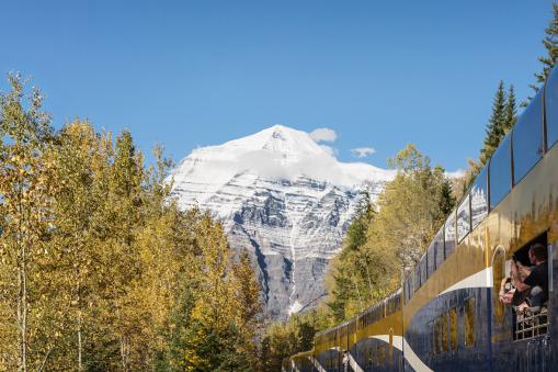 Rocky Mountaineer Guests capturing photos of Mount Robson from the GoldLeaf Service vestibule on Journey through the Clouds