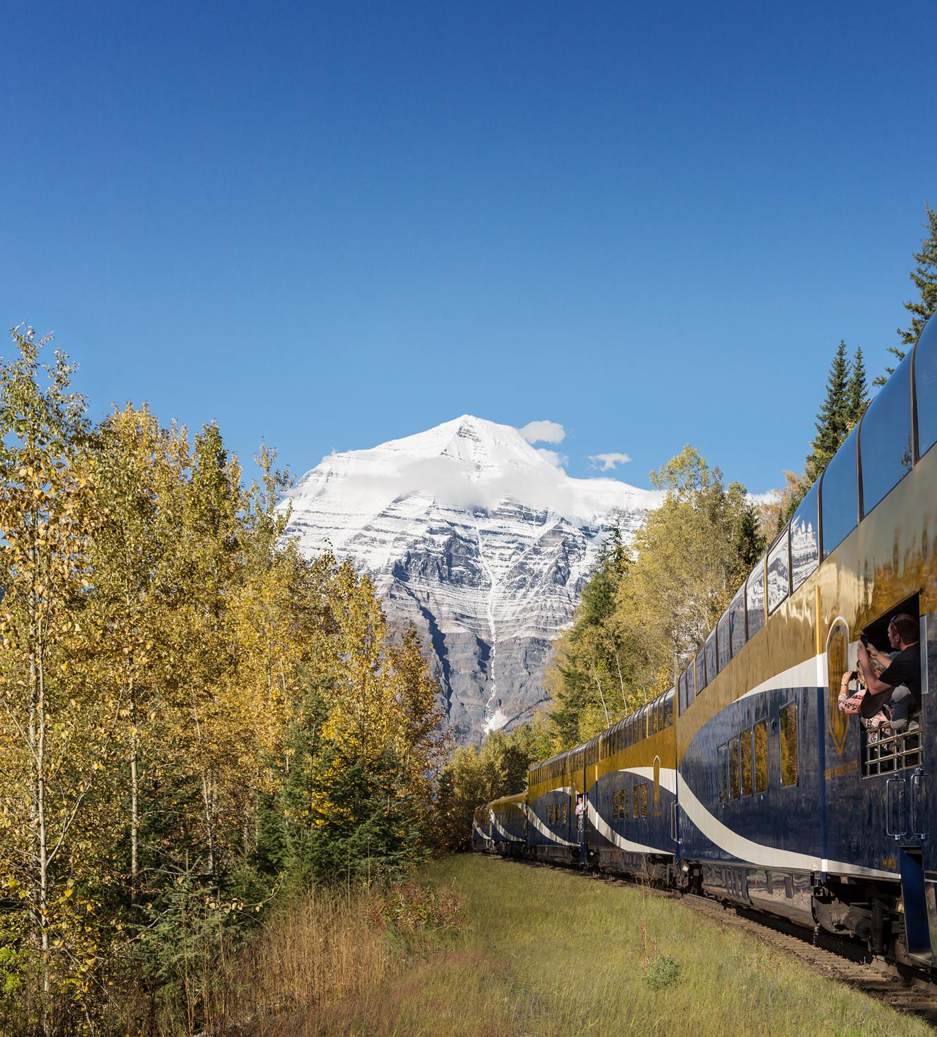 Rocky Mountaineer Guests capturing photos of Mount Robson from the GoldLeaf Service vestibule on Journey through the Clouds